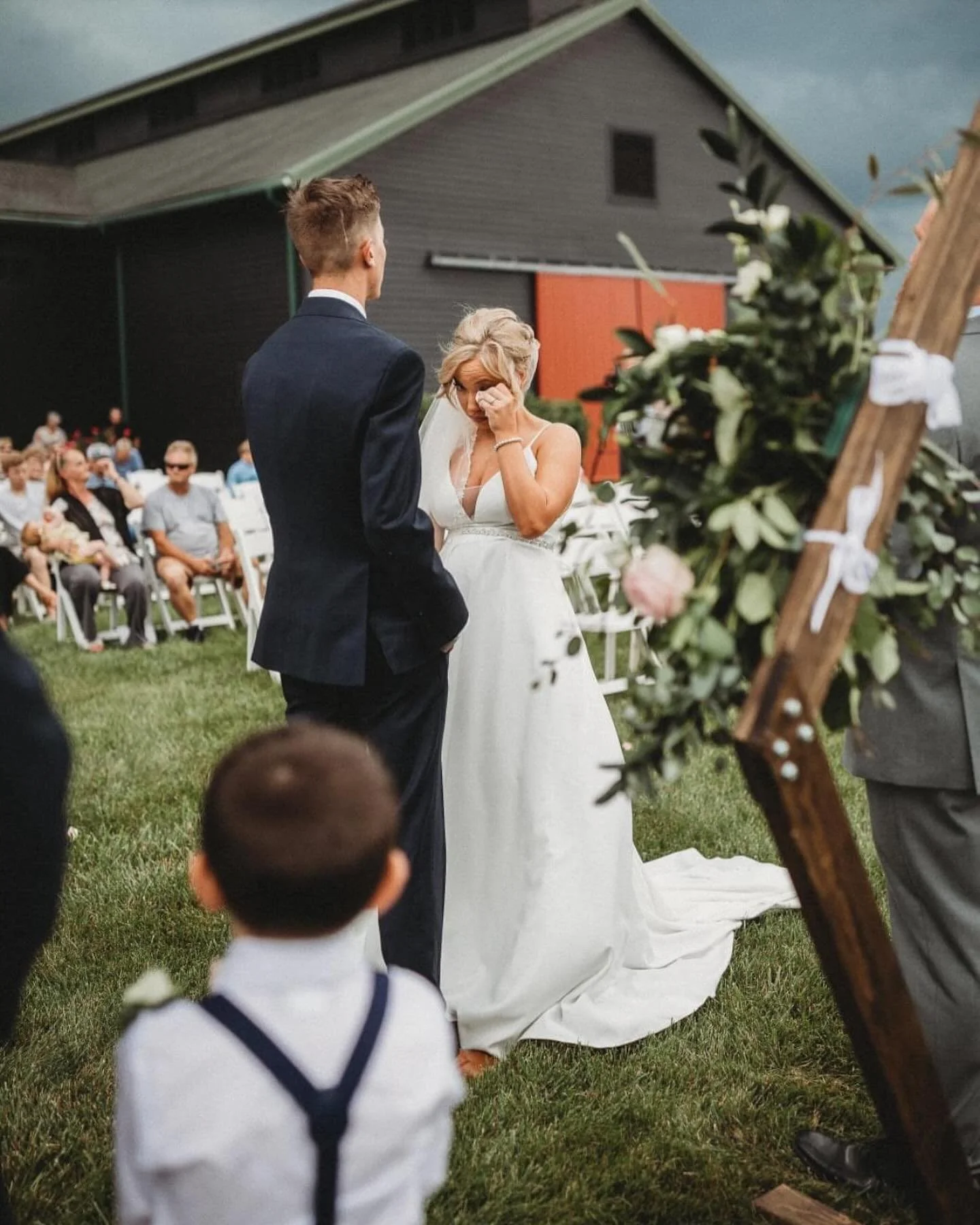 Bride wiping a tear during the ceremony at The Show Barn